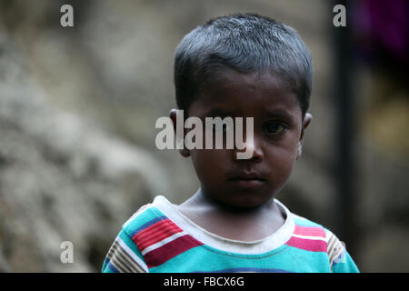 A portrait of a poor boy from India in his unfortunate condition. Stock Photo