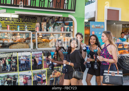 San Juan, Puerto Rico. 14th January, 2016. A group of young women pose in front of the food stall at the San Sebastian Festival. Stock Photo