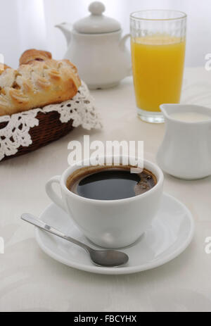 Morning cup of coffee and freshly baked pastries, juice and milk Stock Photo