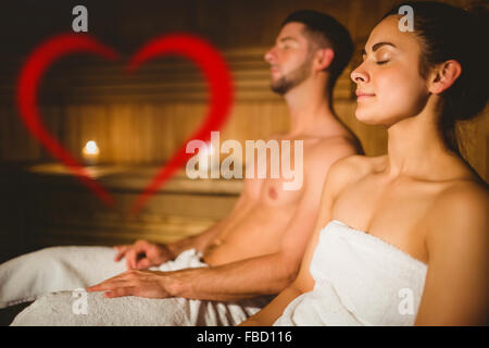 Composite image of happy couple enjoying the sauna together Stock Photo