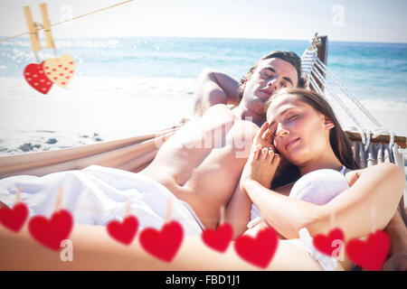 Composite image of happy couple napping together in the hammock Stock Photo