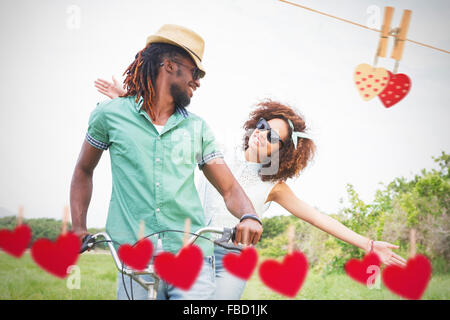 Composite image of young couple on a bike ride Stock Photo