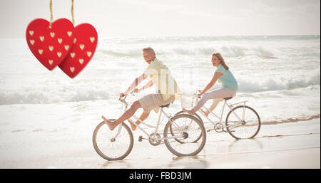 Composite image of happy couple on a bike ride Stock Photo
