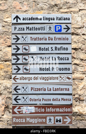 Italian road sign in the town of Assisi, Italy,  pointing the way to local hotels and places of interest. Stock Photo