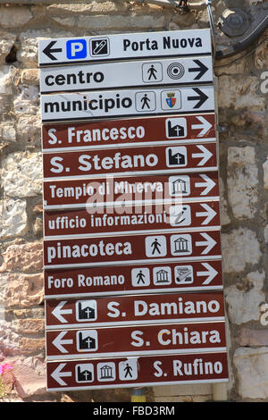 Italian road sign in the town of Assisi, Italy,  pointing the way to local hotels and places of interest. Stock Photo