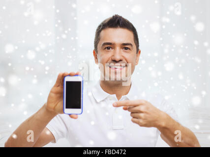 happy man with smartphone at home Stock Photo