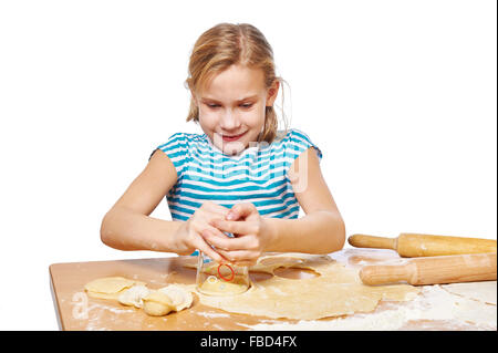 Girl kneads the dough for dumplings on the kitchen table isolated Stock Photo