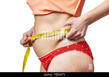 Woman measuring waist with a measuring tape and showing fatty deposits Stock Photo