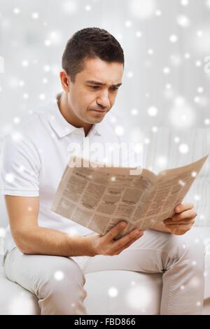 sad man reading newspaper at home Stock Photo