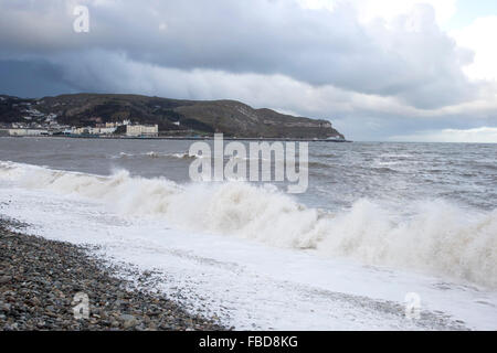 Llandudno North Shore on a stormy day with rough seas and the Great Orme in the background Stock Photo