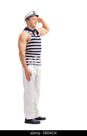 Full length portrait of a young sailor standing straight and saluting someone isolated on white background Stock Photo