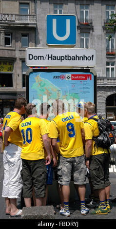 Swedish football fans looking at map Stock Photo