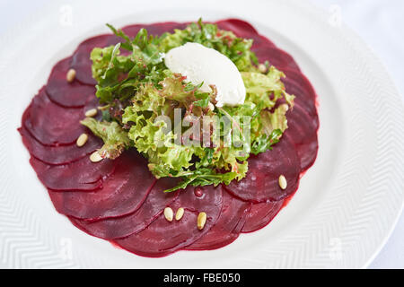 Beetroot salad on white plate studio shot Stock Photo