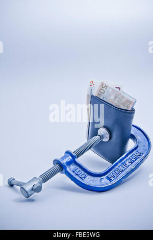wallet squeezed in a clamp Stock Photo
