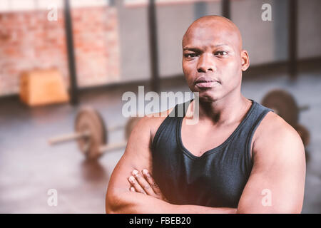 Composite image of portrait of bald bodybuilder with arms crossed Stock Photo