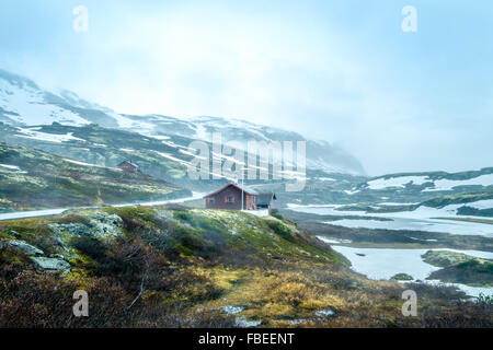 Norway landscape, a small village in inclement weather snowstorm and fog in the mountains. Beautiful Nature Norway. Stock Photo