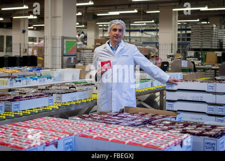 Chairman of the management board of chocolate manufacturer Ritter Sport, Andreas Ronken, stands in the consignment department holding a chocolate bar in his hands at the company headquarter in Waldenbuch, Germany, 8 December 2015. Photo: Daniel Maurer/dpa Stock Photo