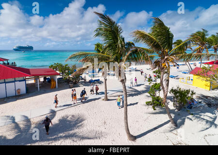 Tourists enjoy a sunny day on the sandy beach of Princess Cays, Eleuthera in the Bahamas Stock Photo