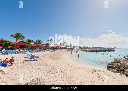 Tourists enjoy a sunny day on the sandy beach Stock Photo