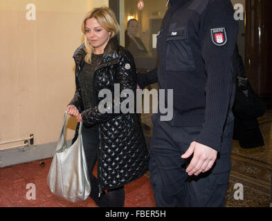 Hamburg, Germany. 15th Jan, 2016. German singer Annett Louisan accompanied by a judicial officer into the courtroom of the house of Criminal Justice in Hamburg, Germany, 15 January 2016. The trial of an alleged extortionist of the singer has begun before the Hamburg District Court in the presence of the singer. A 42-year-old man has been accused of threatening the singer after having contacted her initially on Facebook last April, threatening her and demanding money from her. Photo: CHRISTIAN CHARISIUS/dpa/Alamy Live News Stock Photo