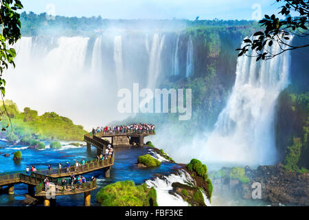 Tourists at Iguazu Falls, one of the world's great natural wonders, on the border of Brazil and Argentina. Stock Photo