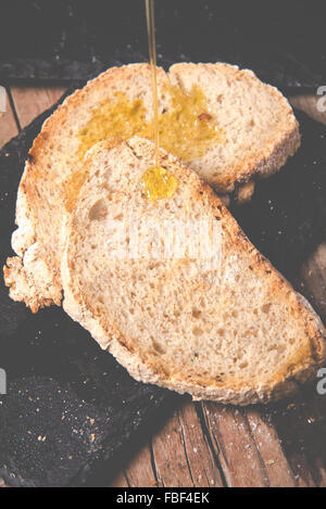 Some sliced bread during the preparation of the typical italian's starter: 'Bruschetta' Stock Photo