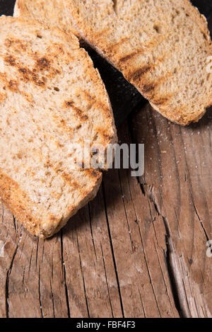 Some sliced bread during the preparation of the typical italian's starter: 'Bruschetta' Stock Photo