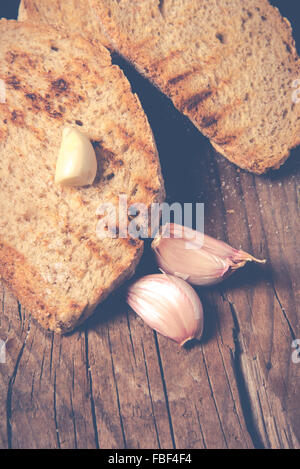 Some sliced bread during the preparation of the typical italian's starter: 'Bruschetta' Stock Photo