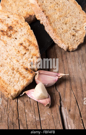 Some sliced bread during the preparation of the typical italian's starter: 'Bruschetta' Stock Photo