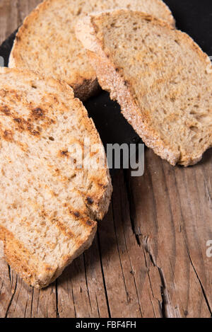 Some sliced bread during the preparation of the typical italian's starter: 'Bruschetta' Stock Photo