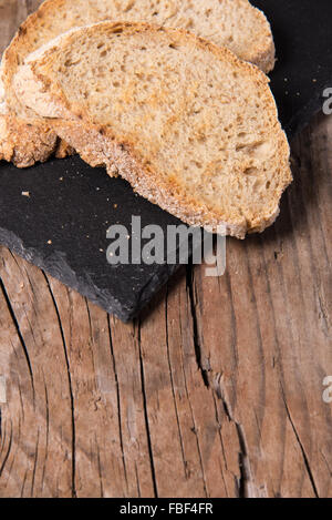 Some sliced bread during the preparation of the typical italian's starter: 'Bruschetta' Stock Photo