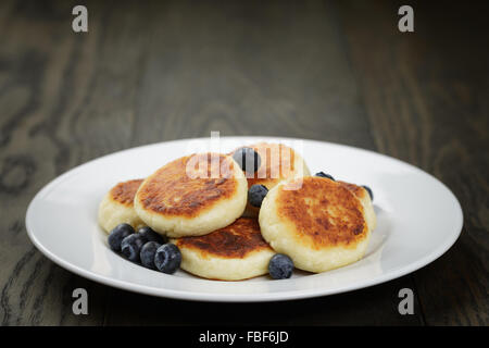sirniki traditional russian pancakes from cottage cheese with blueberries Stock Photo
