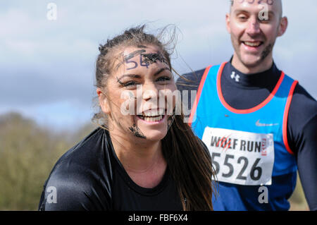 Male and female runners at obstacle course race, UK Stock Photo