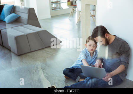 Father and son using laptop Stock Photo