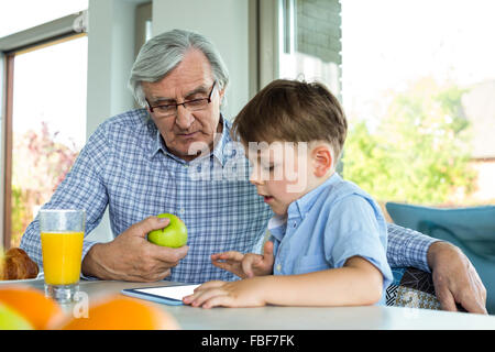 Grandfather and grandson using tablet Stock Photo