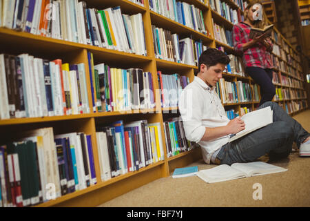 Male student working on floor Stock Photo