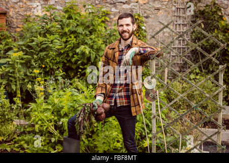 Young man holding beetroot Stock Photo