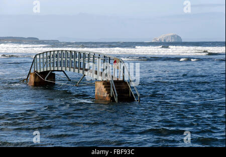 The 'Bridge to Nowhere' in the Firth of Forth estuary near Dunbar in East Lothian, Scotland with the Bass Rock beyond. Stock Photo