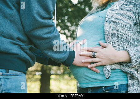 Young pregnant couple in the park Stock Photo