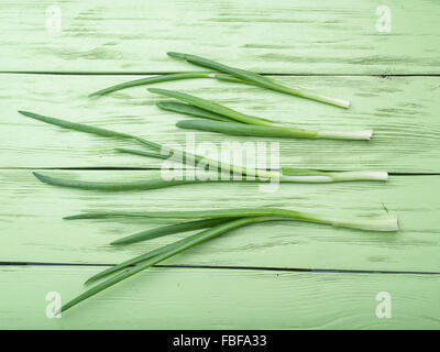Green onion on the wooden background. Stock Photo