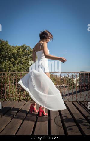 Young Woman In High Heels Dancing On Rooftop