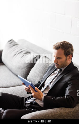 Focused businessman using tablet Stock Photo