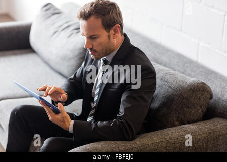 Focused businessman using tablet Stock Photo
