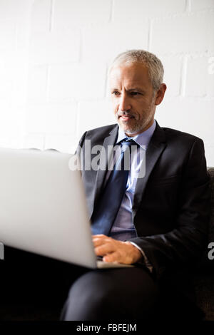 Businessman using laptop Stock Photo