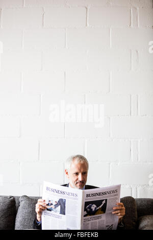 Businessman reading newspaper Stock Photo