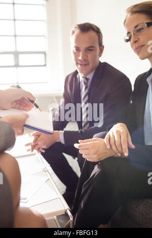 Colleagues signing a document Stock Photo