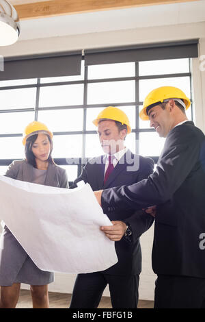 Business people wearing safety helmets Stock Photo
