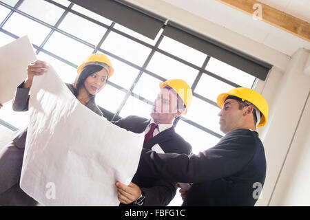 Business people wearing safety helmets Stock Photo