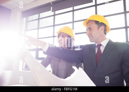 Business people wearing safety helmets Stock Photo