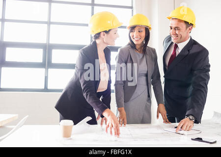 Business people wearing safety helmets Stock Photo